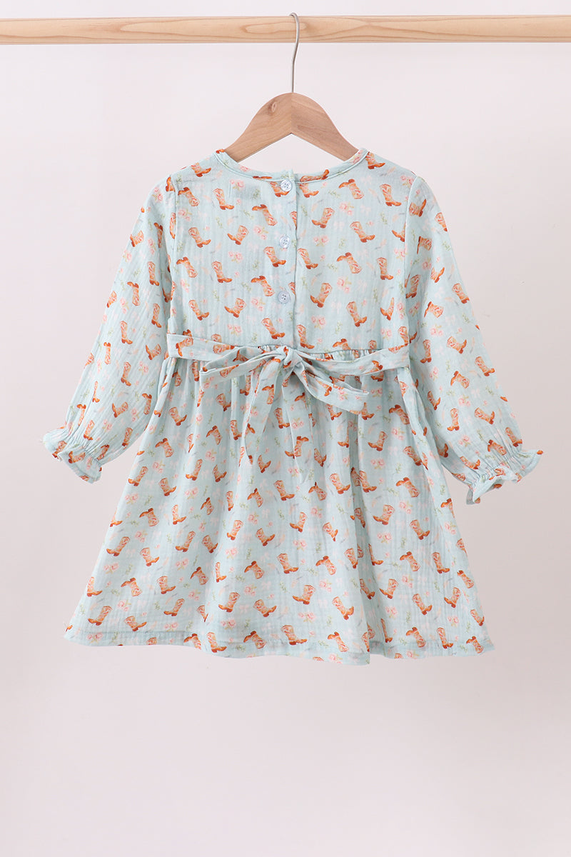 Children's dress with fox pattern on a hanger against a light pink background