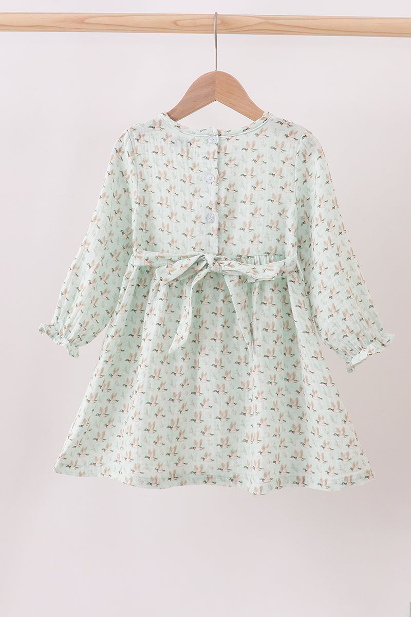 Floral dress on a hanger against a light background