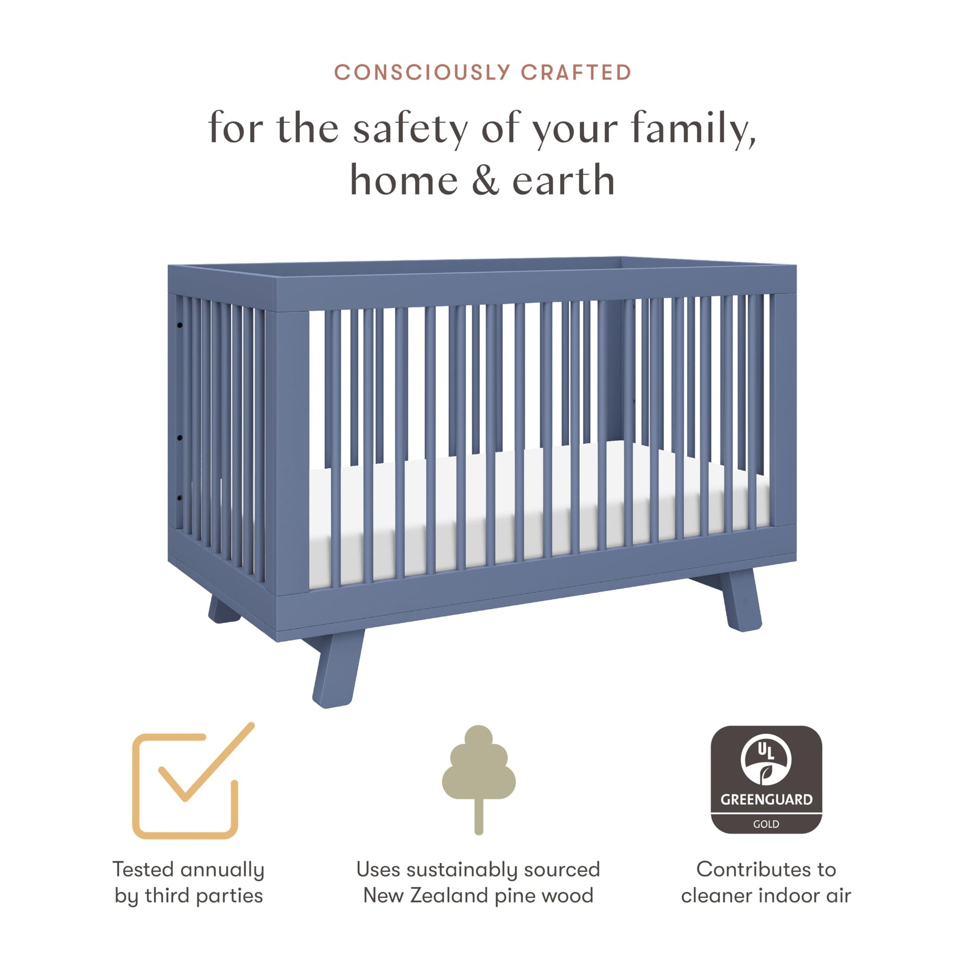 Blue crib with safety and sustainability features on a white background