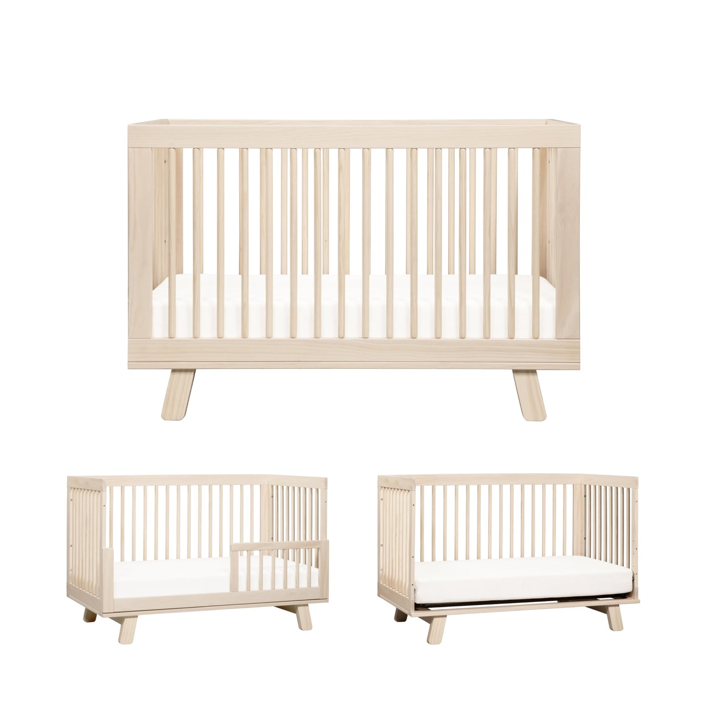 Beige crib with mattress on a white background