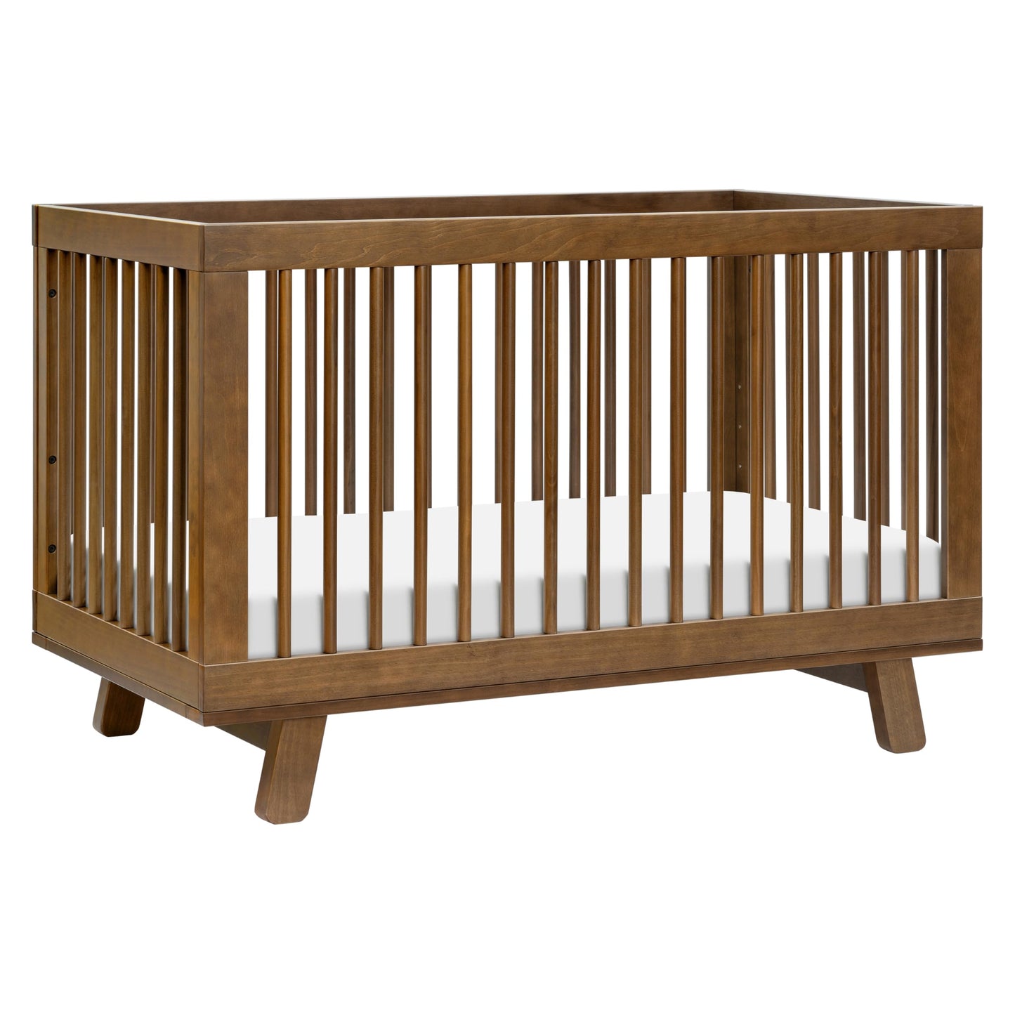 Wooden crib with white mattress on a white background