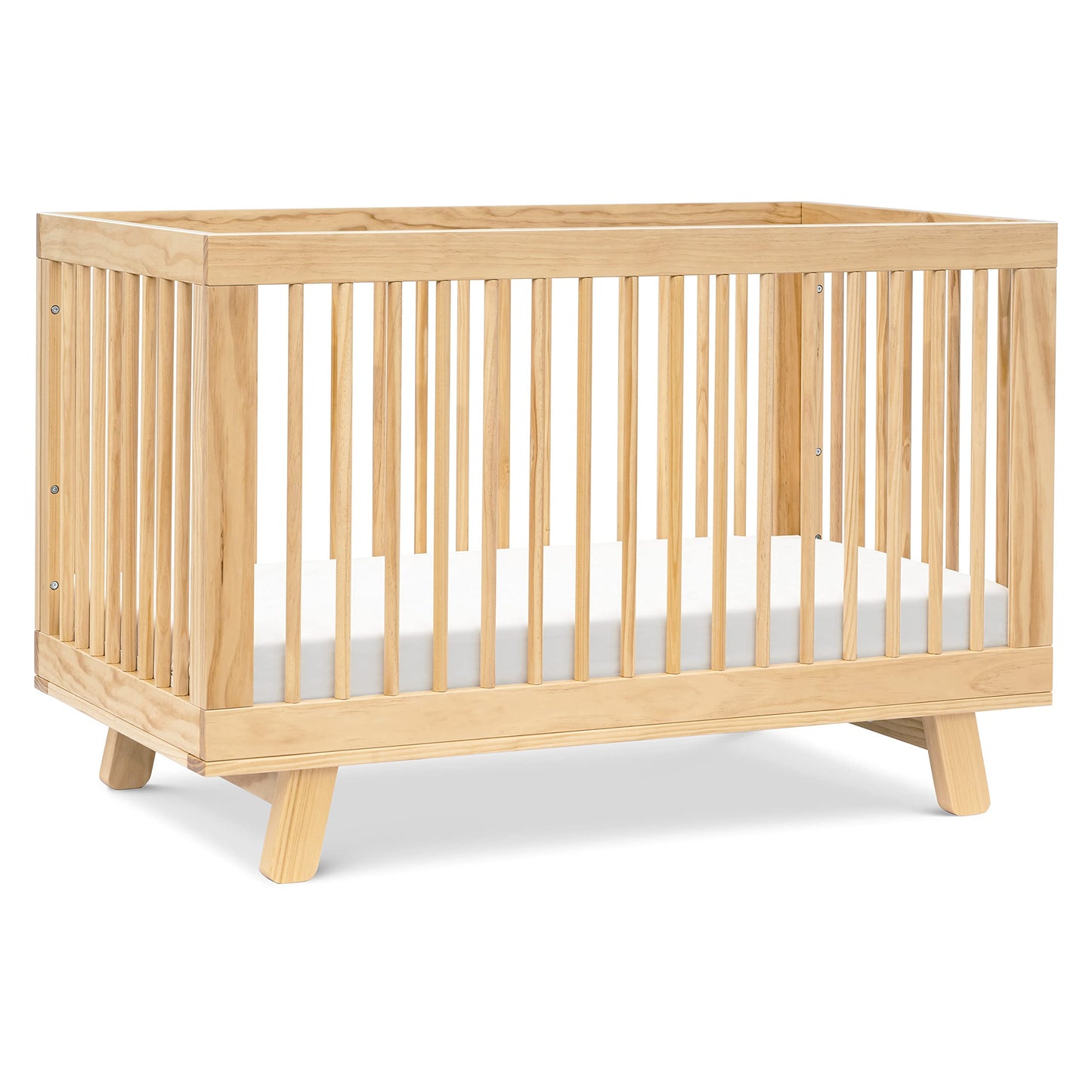 Wooden crib with a white mattress on a white background