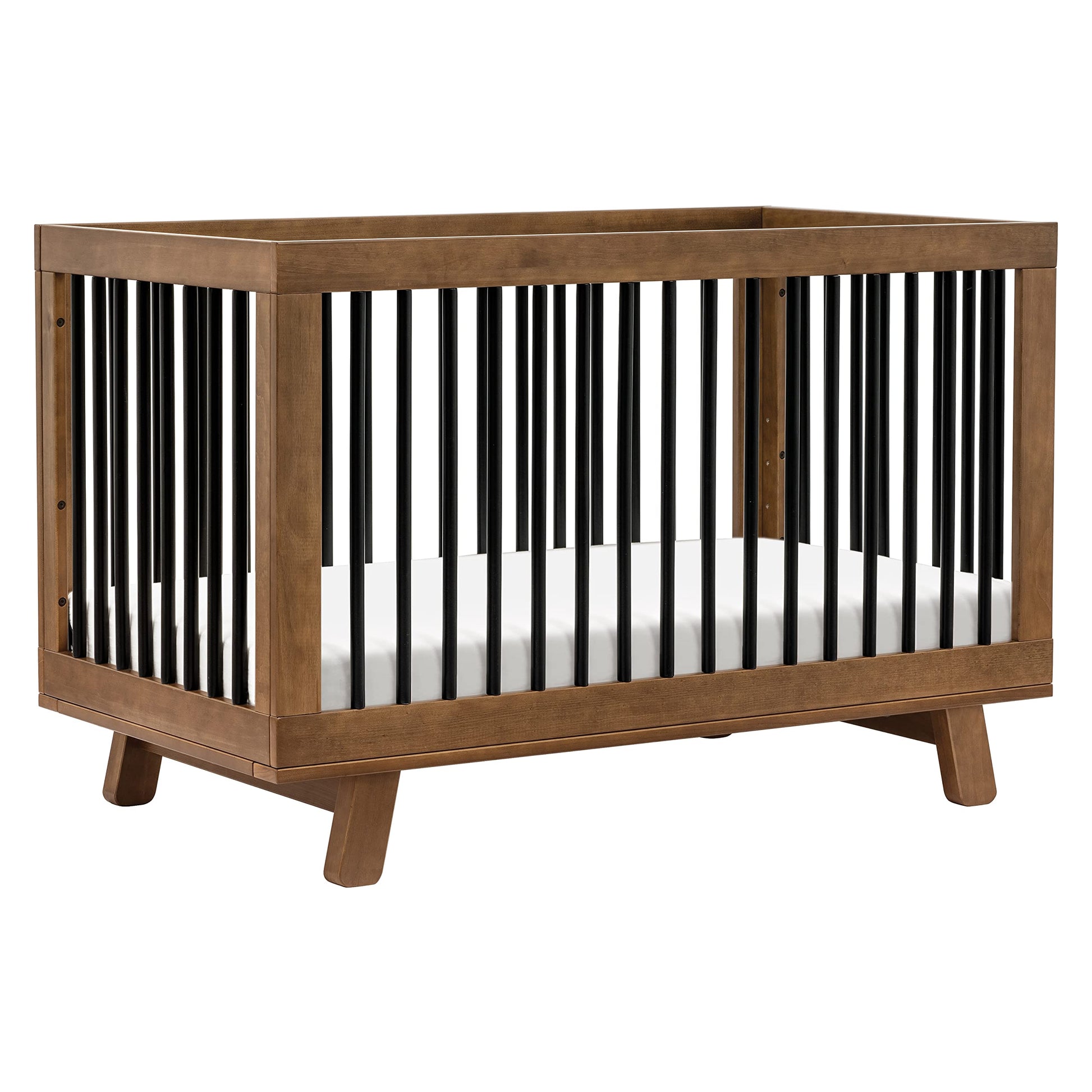Wooden crib with black and white striped bars on a white background