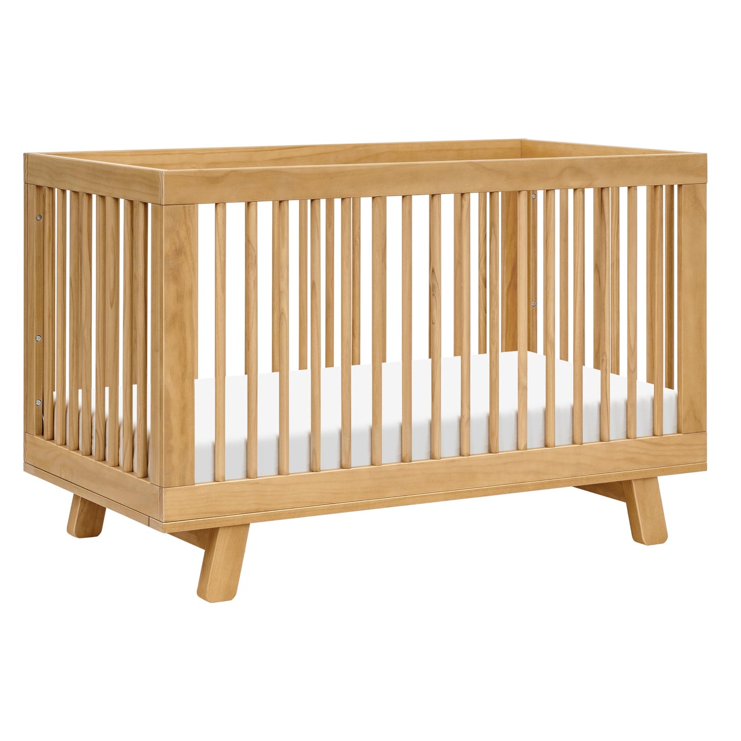 Wooden crib with a white mattress on a white background
