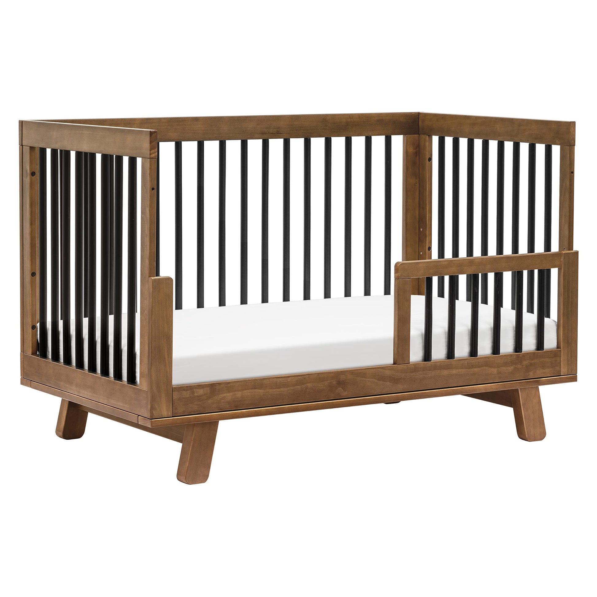 Wooden crib with black and white striped sides on a white background