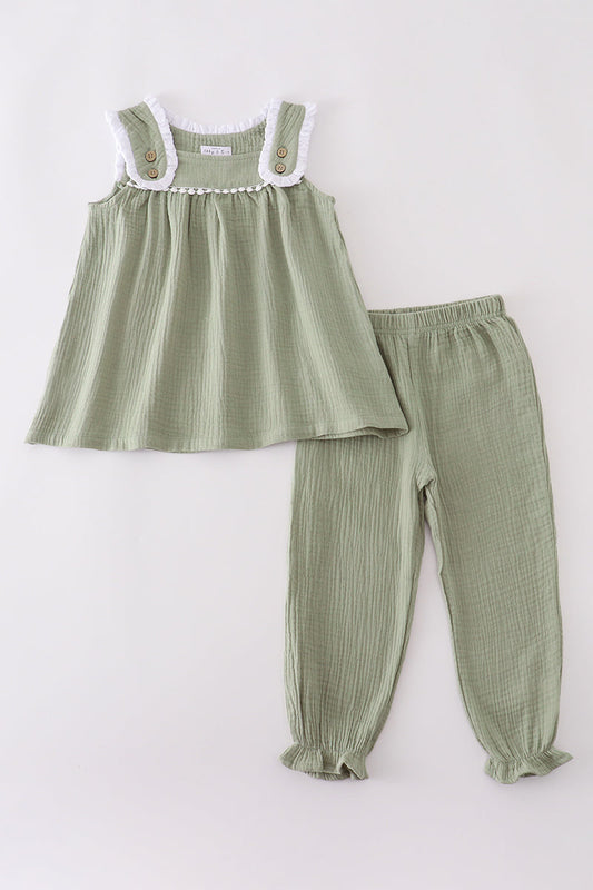 Green checkered dress and pants set on a white background