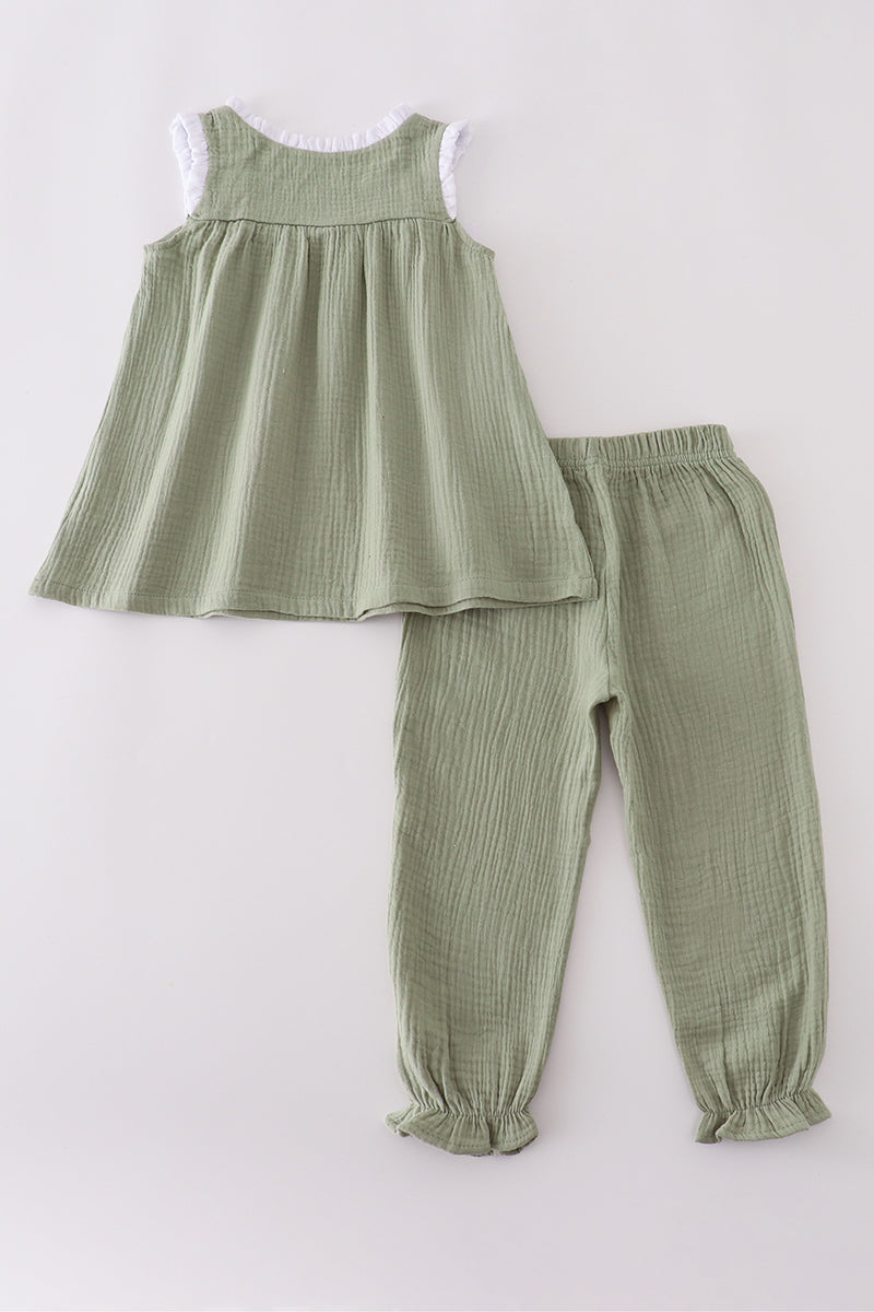 Green ribbed sleeveless top and pants set on a white background