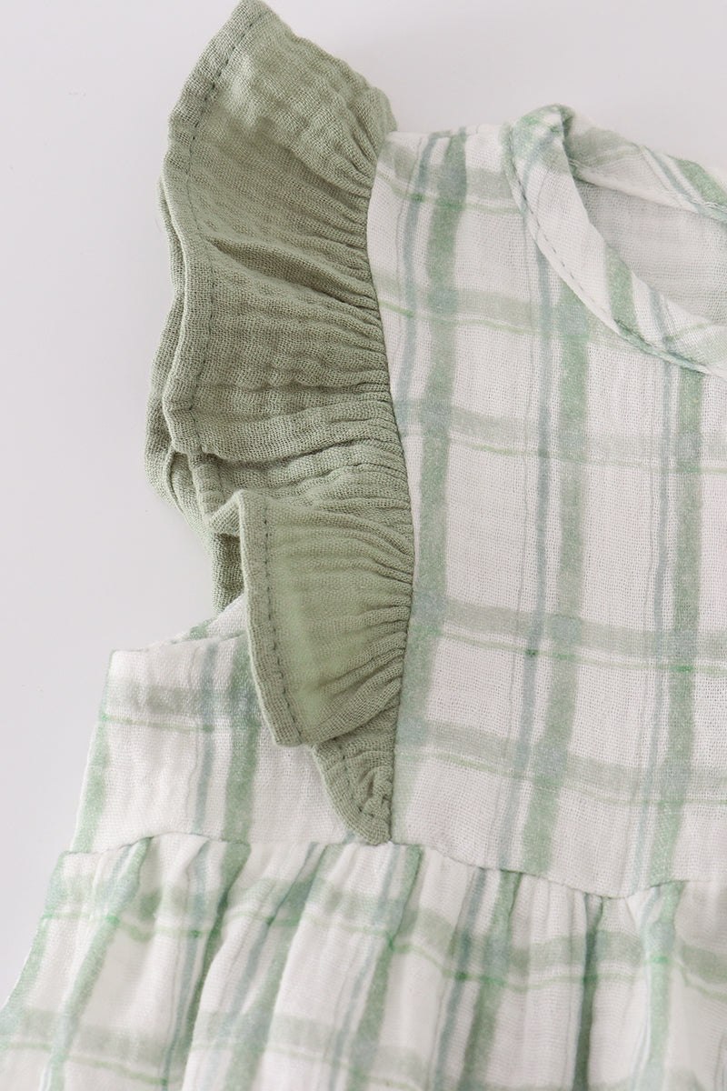 Green and white checkered fabric with a textured green sleeve on a light gray background