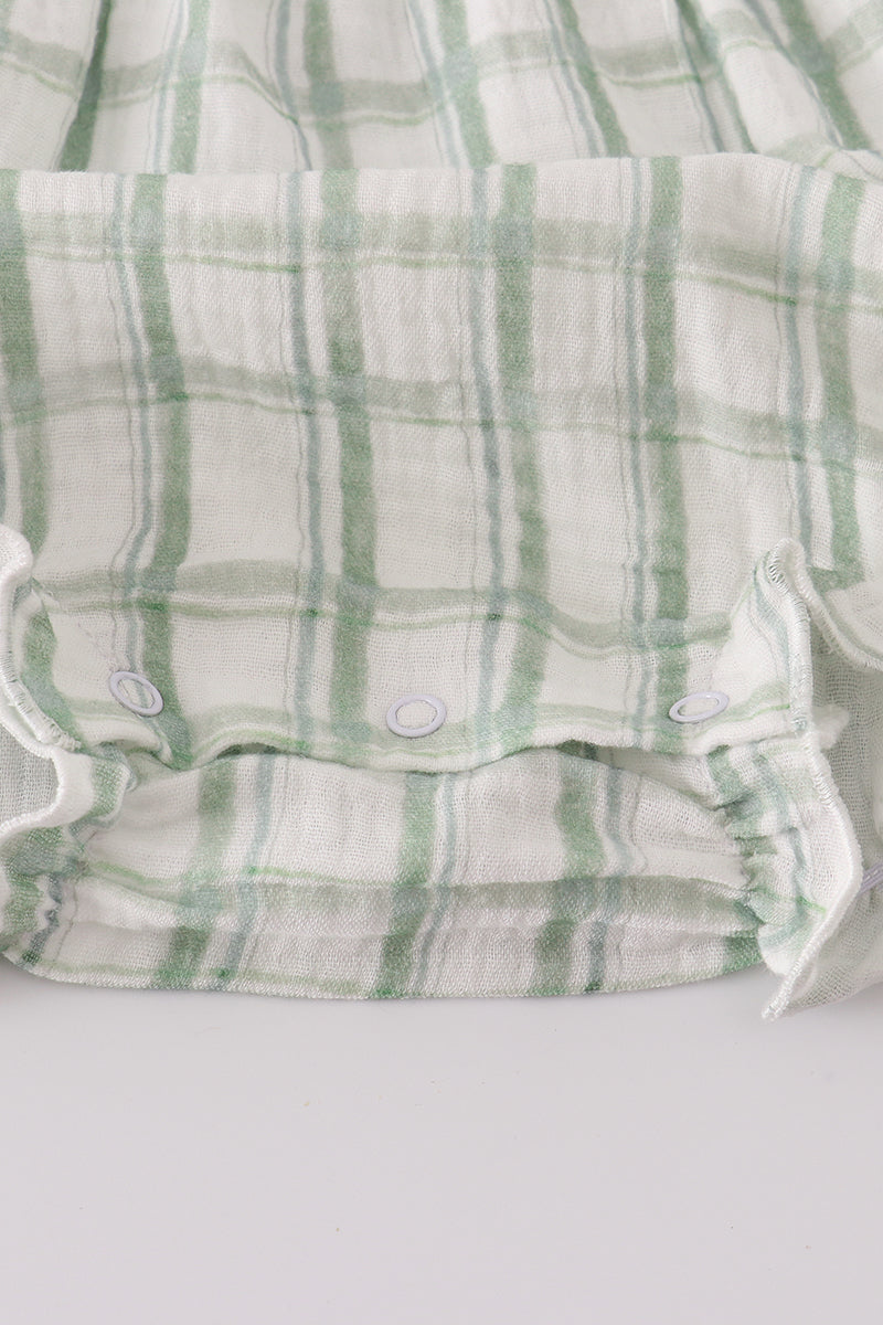 Green and white checkered baby romper on a light gray background