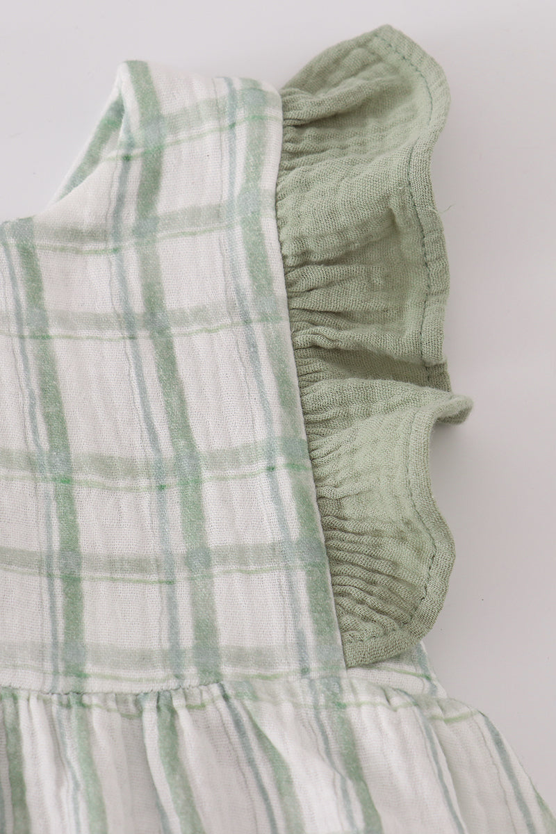 Green and white checkered dress with ruffled details on a light background