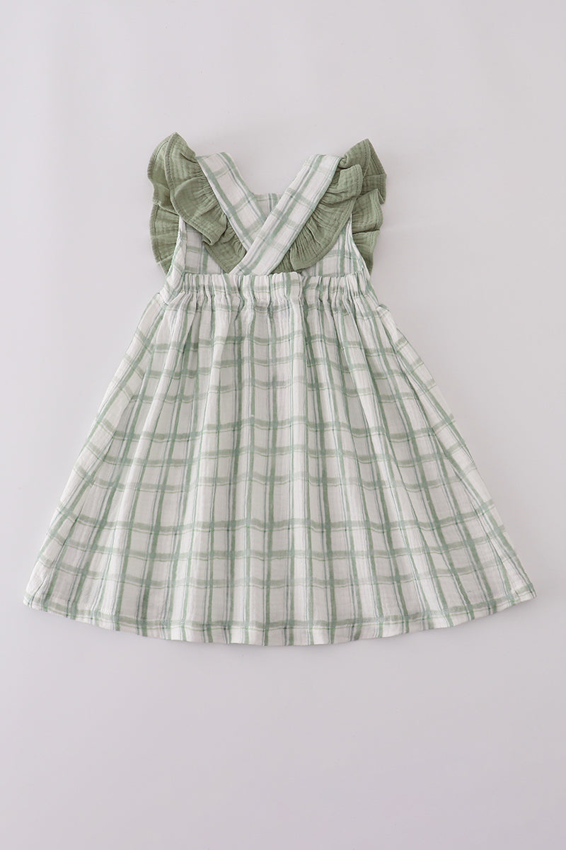 Green plaid dress with ruffled sleeves on a light gray background