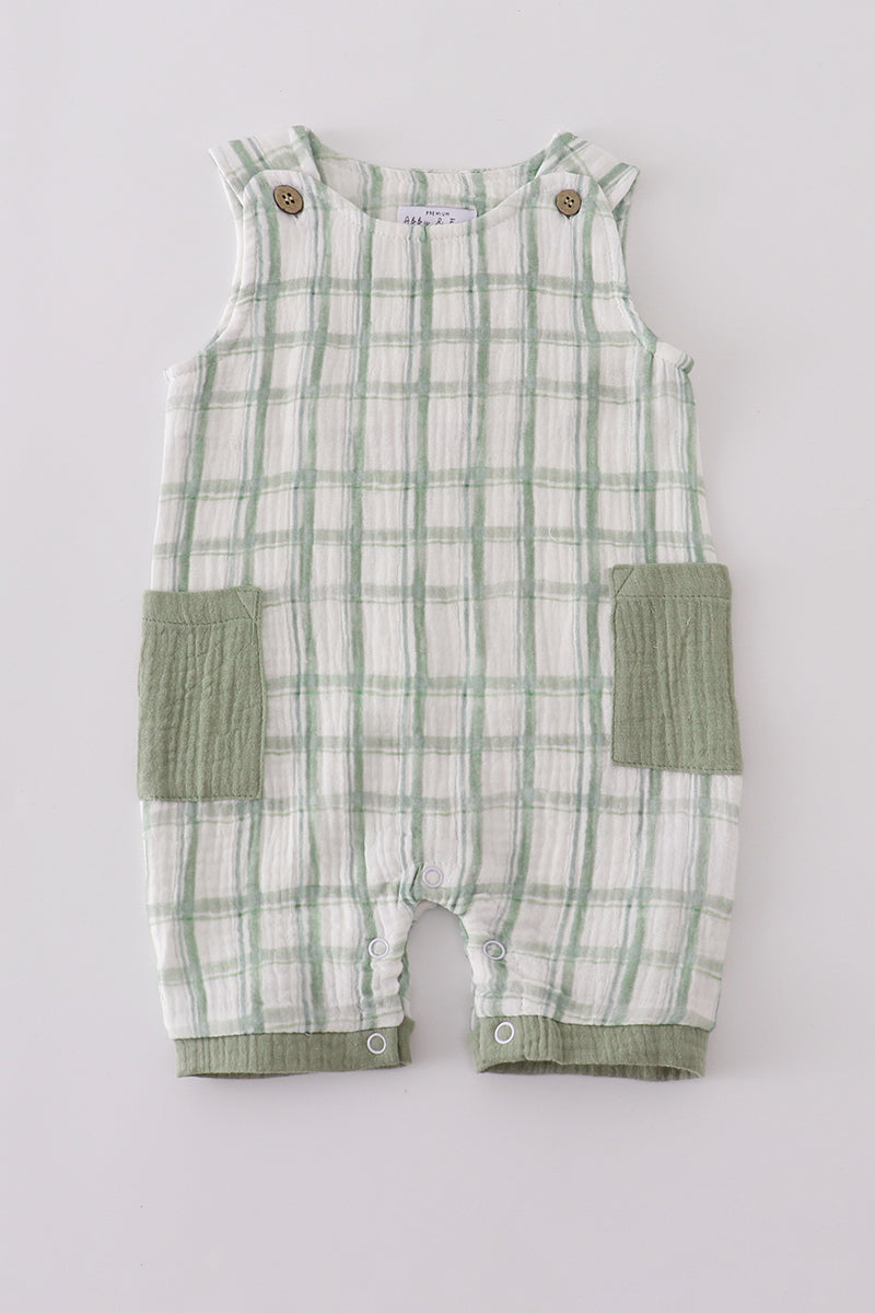 Green and white checkered baby romper with pocket on a light gray background