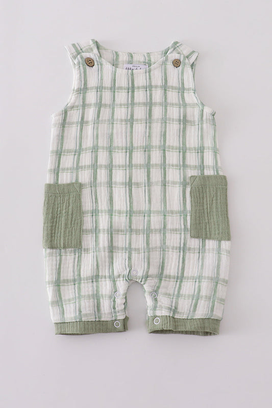 Green and white checkered baby romper with pocket on a light gray background