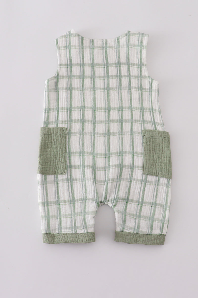 Green and white checkered baby romper on a light gray background