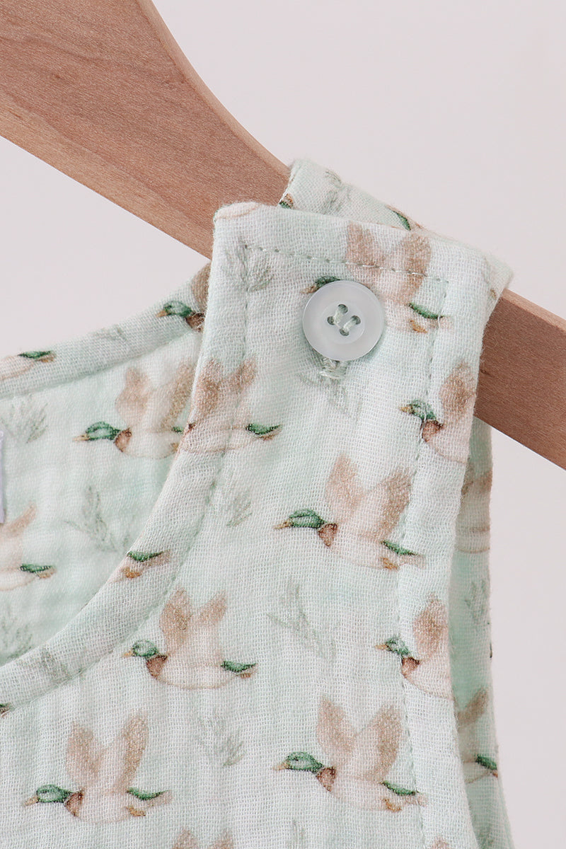 Floral-patterned fabric with a button on a wooden hanger against a light background