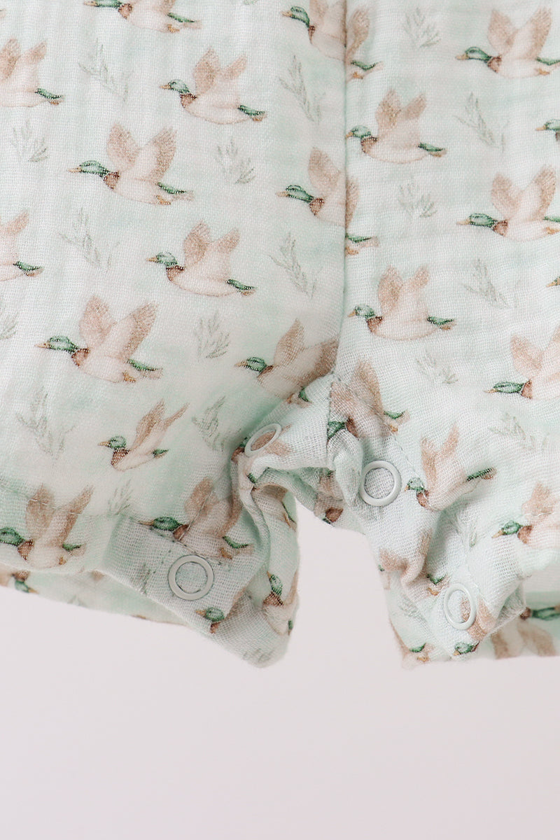 Floral patterned fabric with a close-up of a folded piece on a light pink background