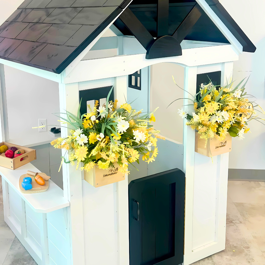 Children's playhouse with flower arrangements and toys inside