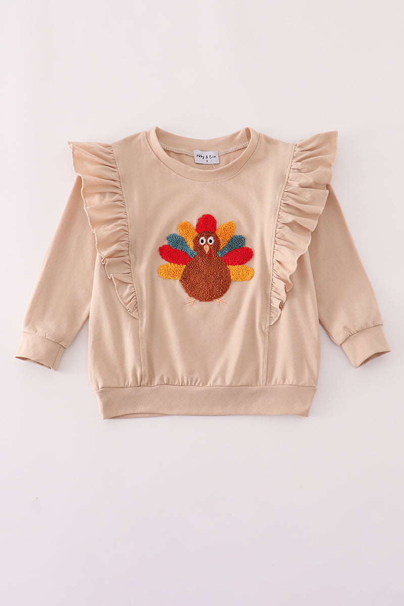 Beige sweatshirt with a colorful turkey applique on a white background