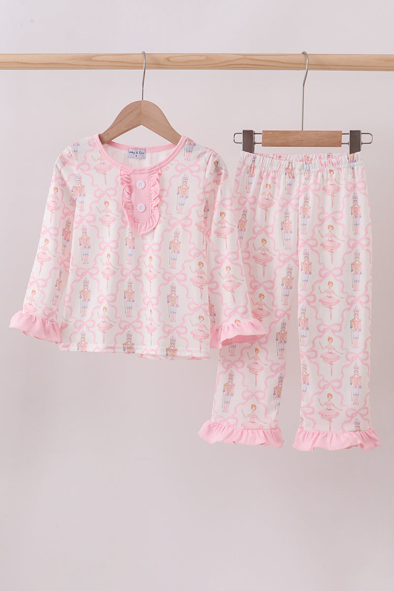 Children's pajama set with floral pattern on a hanger against a plain background