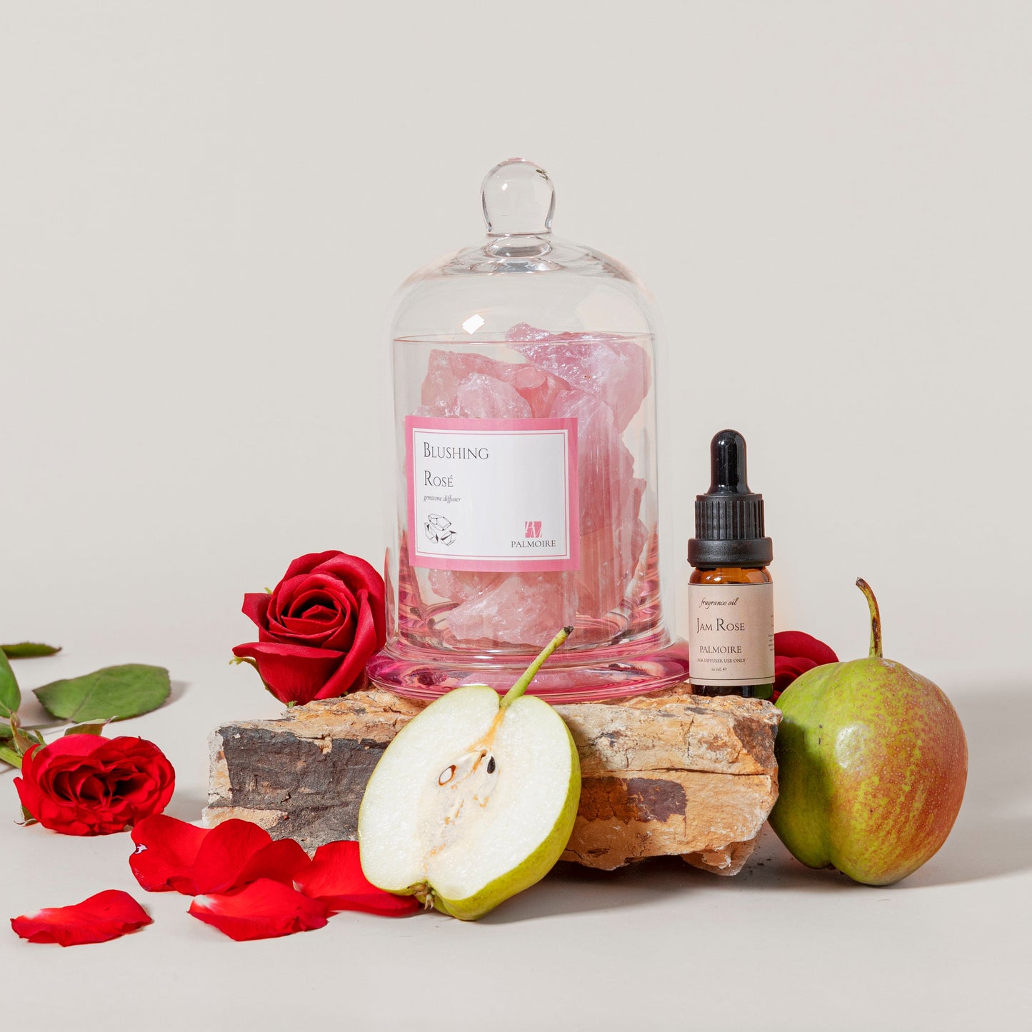 Bottle of rose water, dropper bottle, and pears on a light background