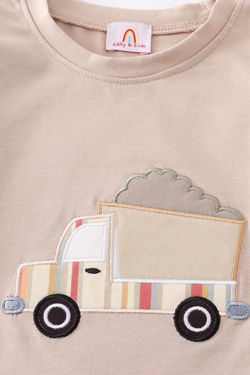 Beige t-shirt with a truck applique and cloud design.