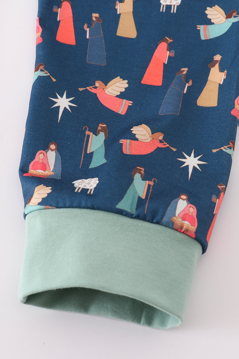 Folded fabric with nativity scene pattern on a blue background