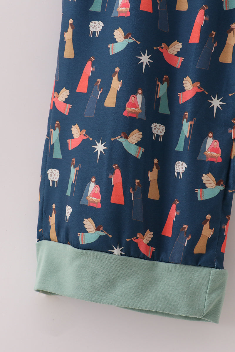 Navy blue fabric with colorful nativity scene pattern on a white background