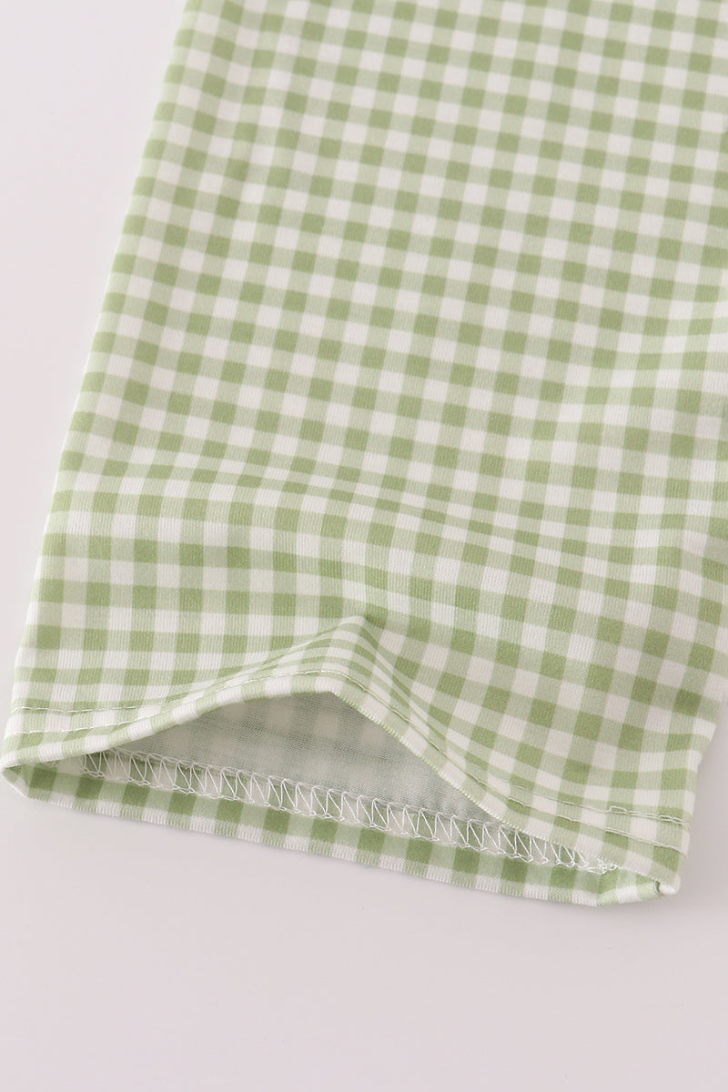 Green and white checkered fabric on a light gray background