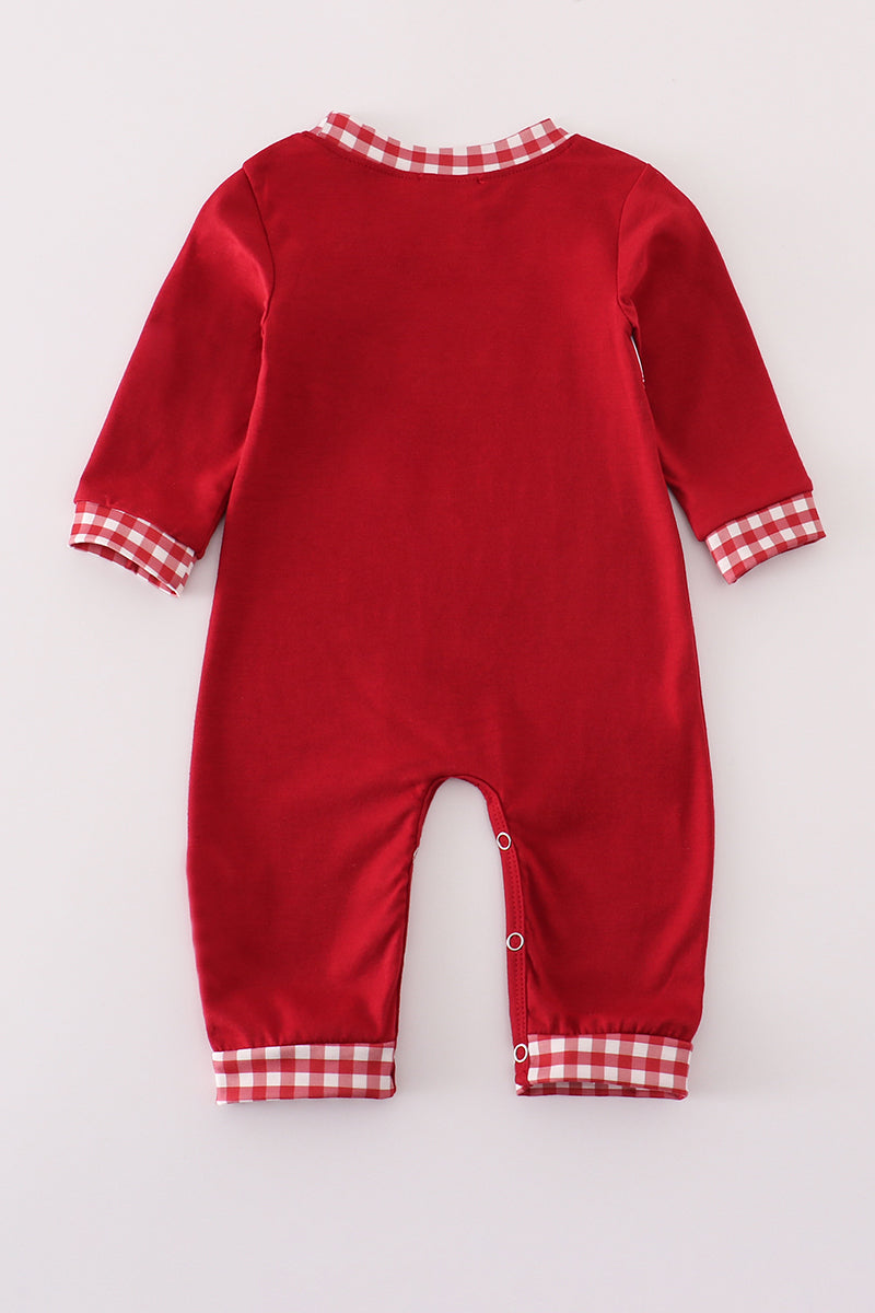 Red baby onesie with checkered trim on a white background