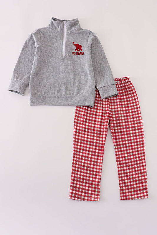 Gray sweatshirt with red logo and red checkered pants on a light gray background