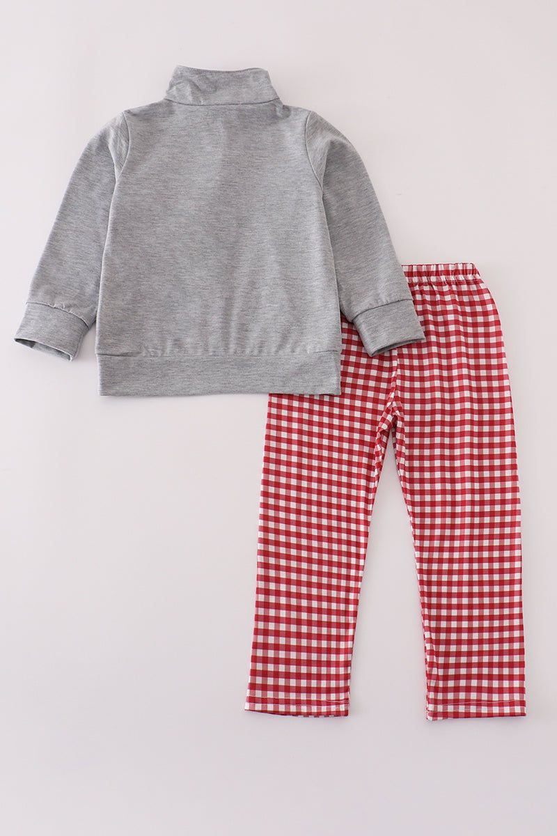 Gray jacket and red checkered pants on a light gray background
