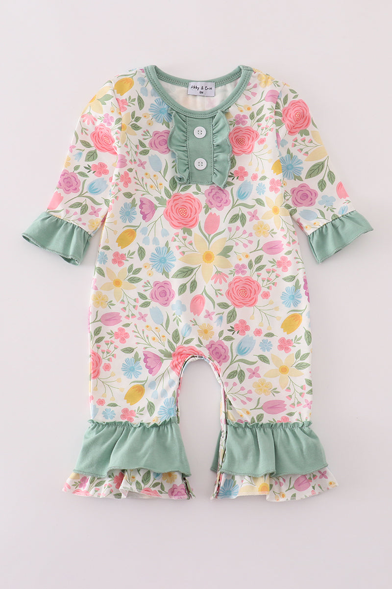 Floral baby romper with ruffled details on a light gray background