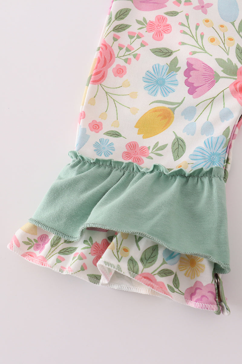 Floral fabric with a green ruffled edge on a white background