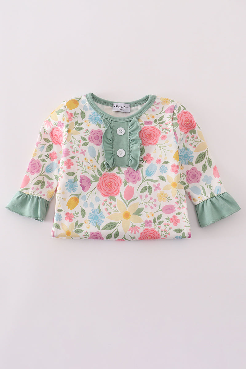 Floral long-sleeve top with ruffled edges on a light gray background