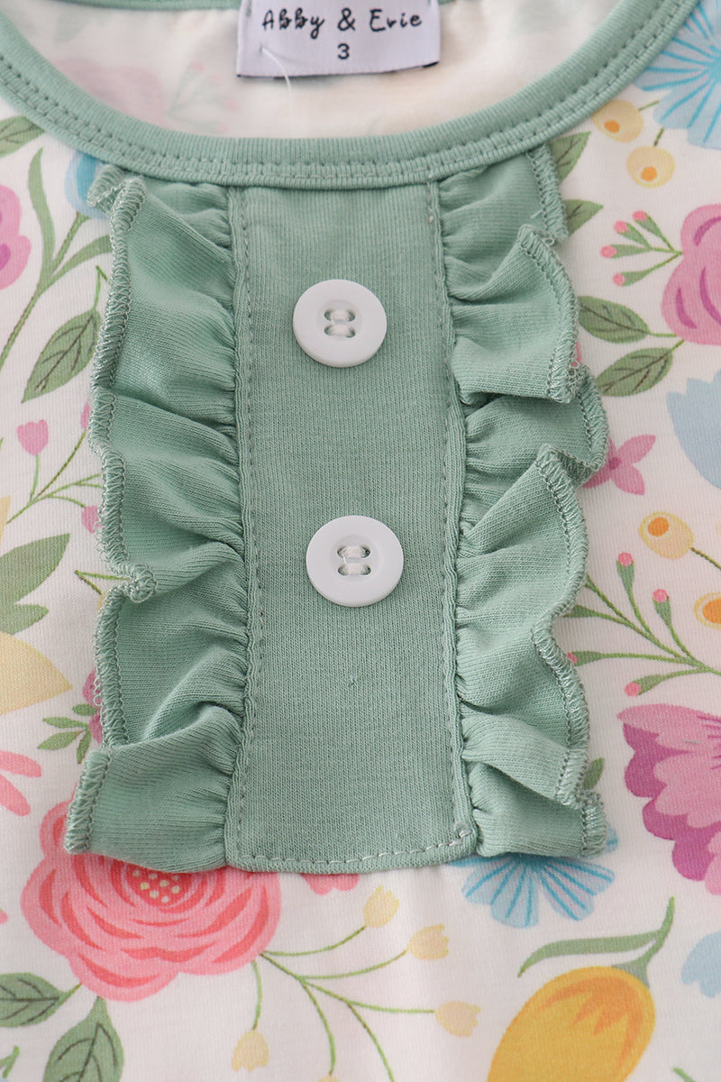 Green pet dress with ruffles and buttons on a floral background