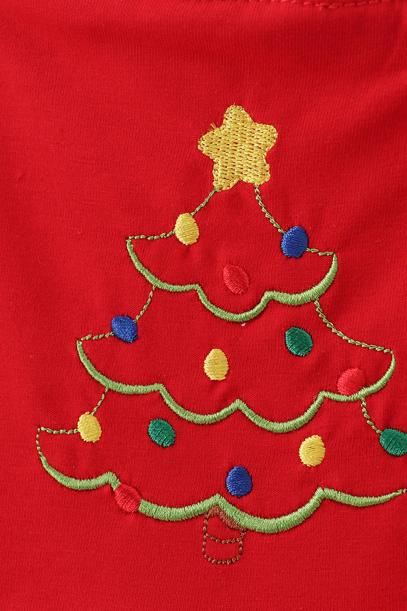 Embroidered Christmas tree design on a red fabric background