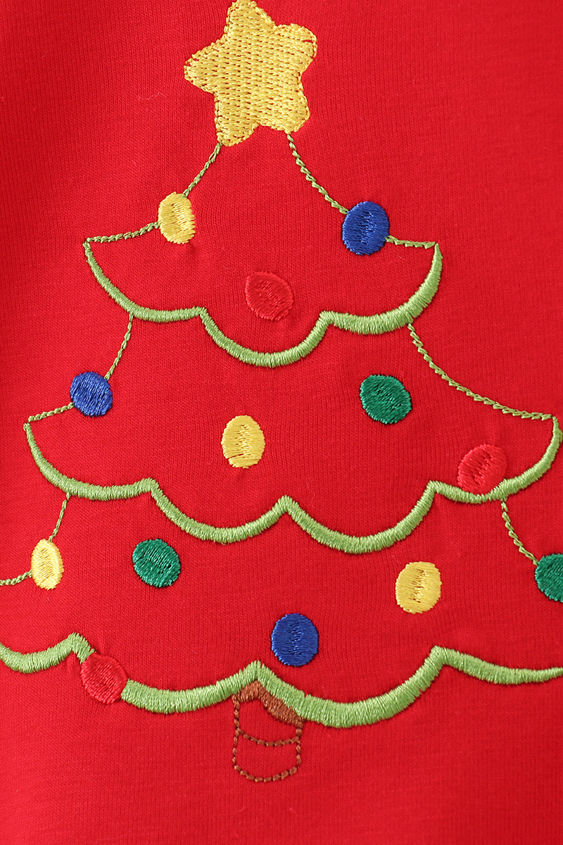 Red shirt with a Christmas tree design featuring colorful decorations on a red background