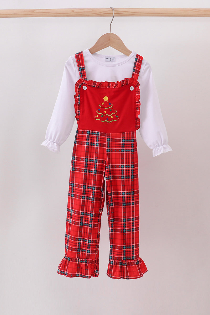 Red plaid overalls with a white shirt underneath on a hanger against a light background