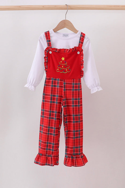 Red plaid overalls with a white shirt underneath on a hanger against a light background
