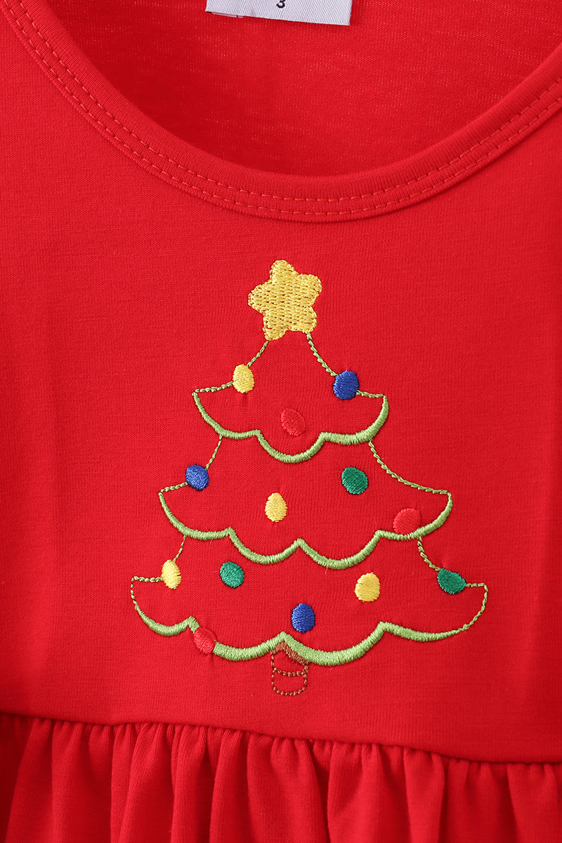 Red dress with a Christmas tree design on a red background