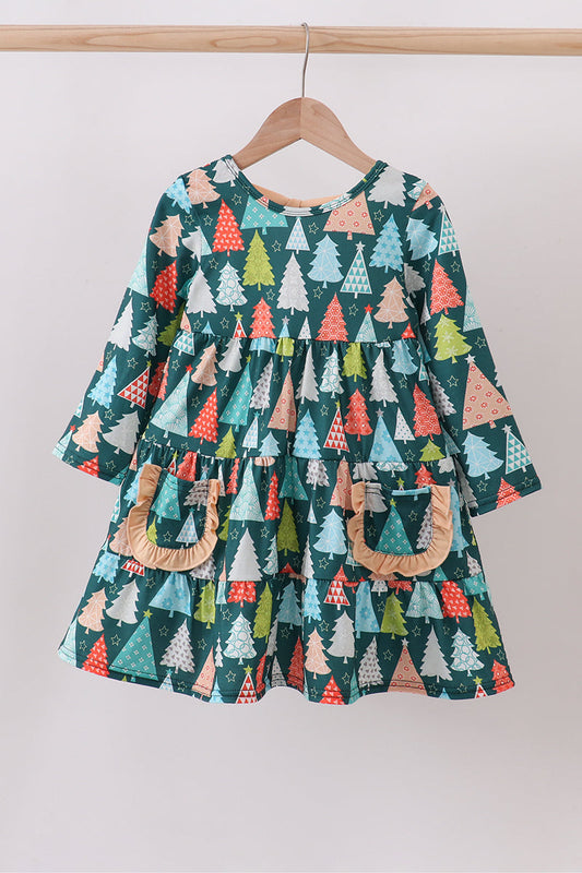 Children's dress with tree pattern on a hanger against a white background