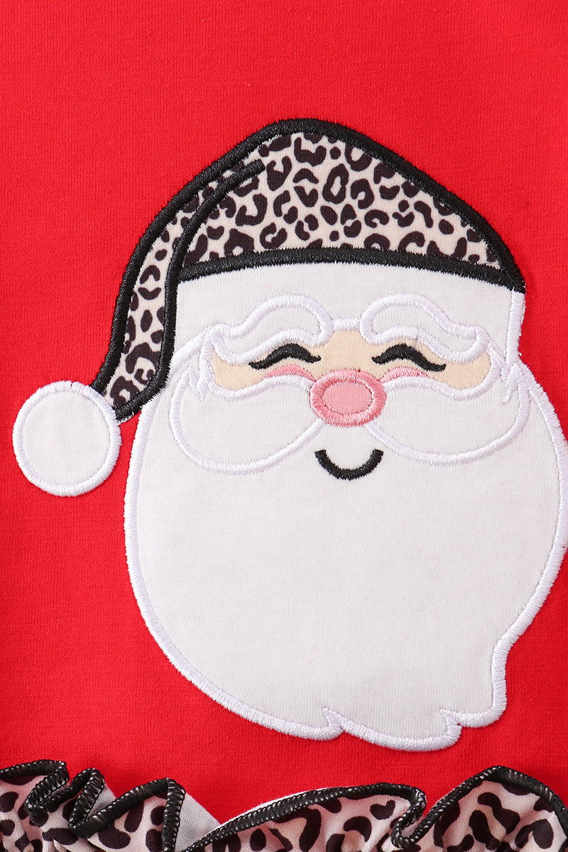 Embroidered patch of Santa Claus with leopard print accents on a red background