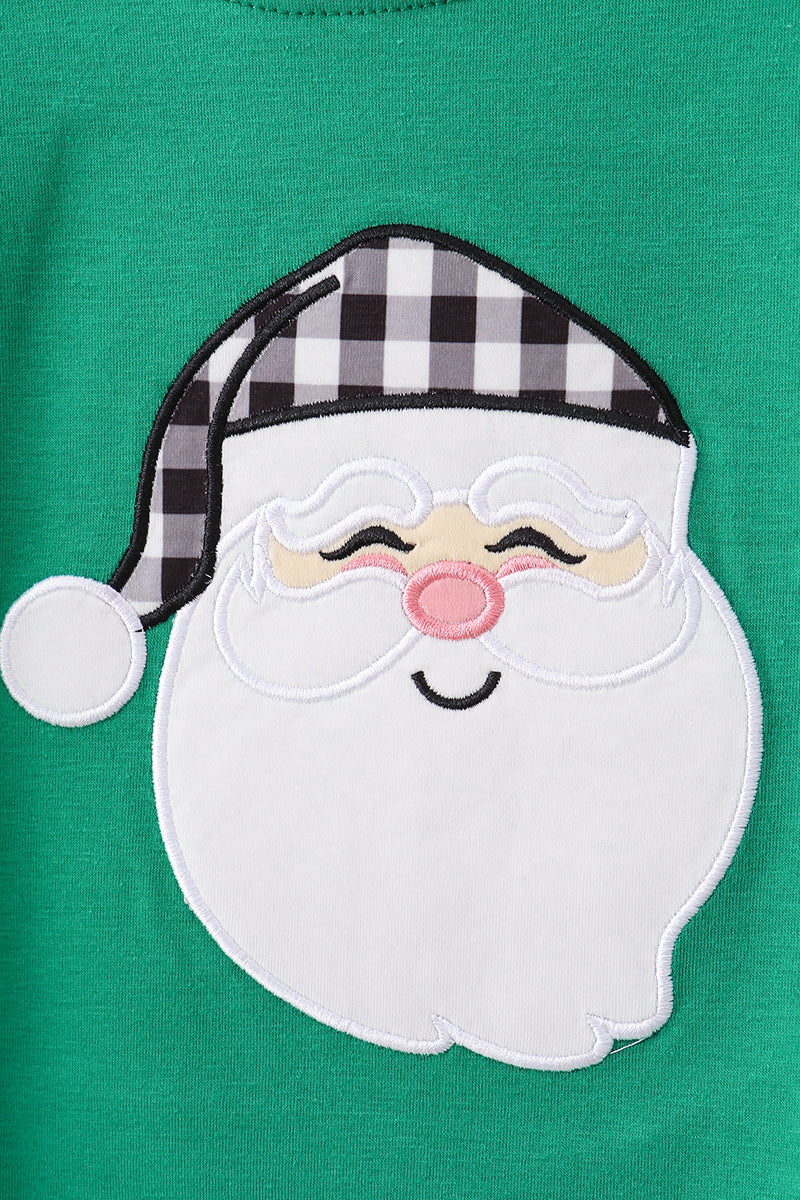 Close-up of a green shirt with a Santa Claus patch featuring a checkered hat.