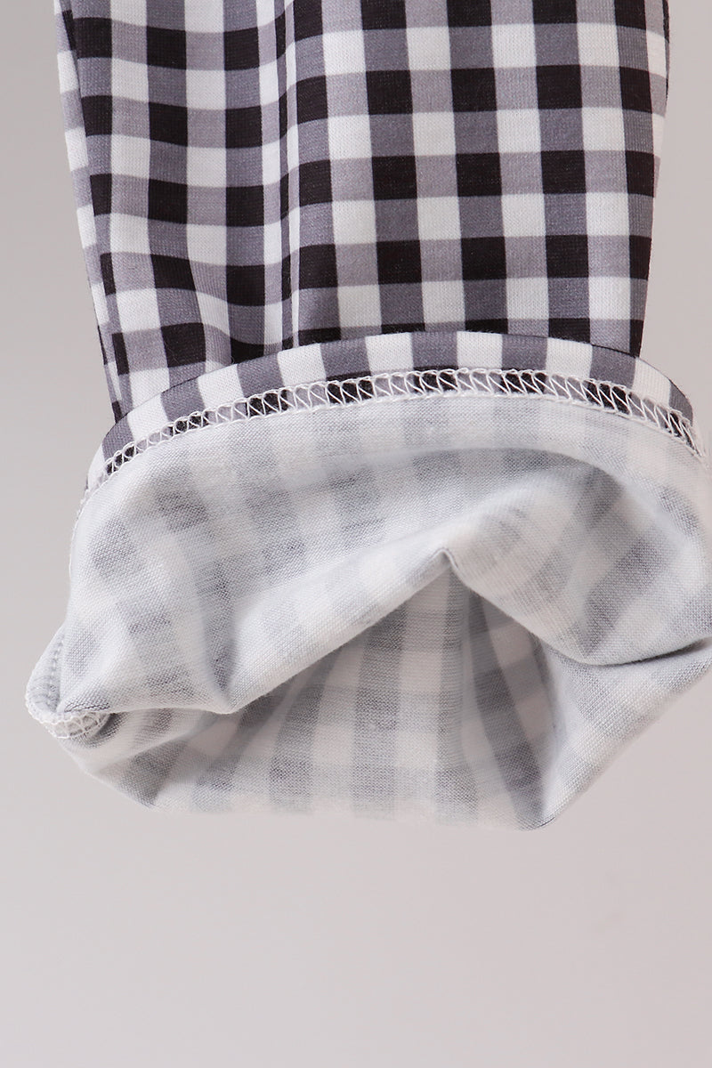 Black and white checkered top with gray striped skirt on a light gray background