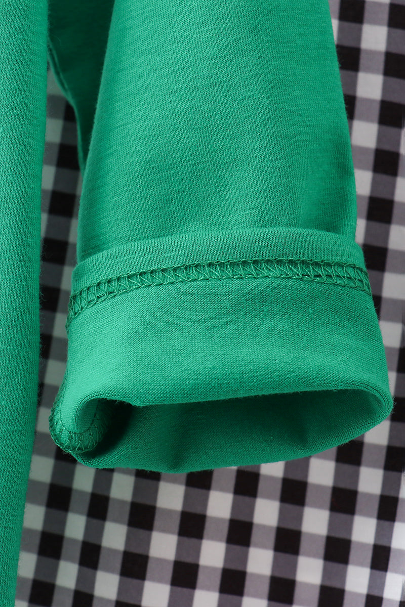 Close-up of a green fabric edge on a checkered background