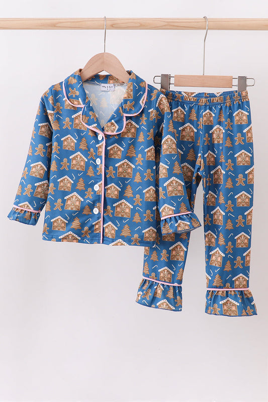 Children's pajama set with gingerbread house pattern on a white background