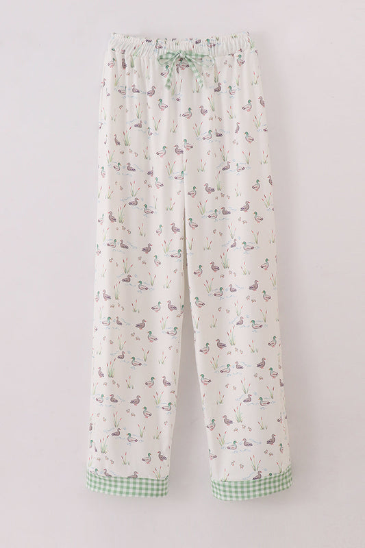 A pair of men's pajama pants with a sage green and multicolor duck print, featuring a drawstring waist.