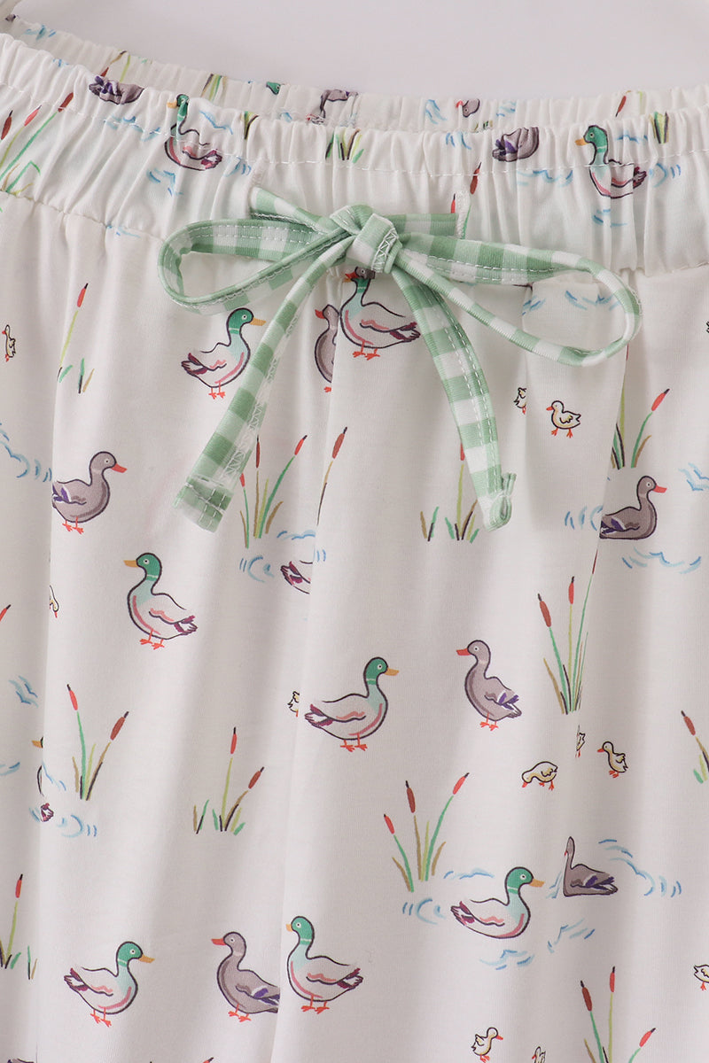 Pajama shorts with duck pattern and green ribbon.