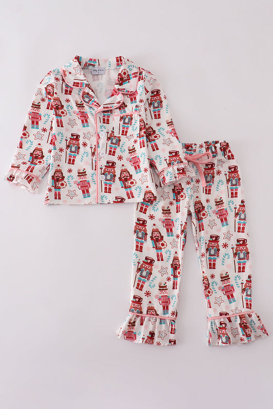 Children's pajama set with nutcracker pattern on a light gray background
