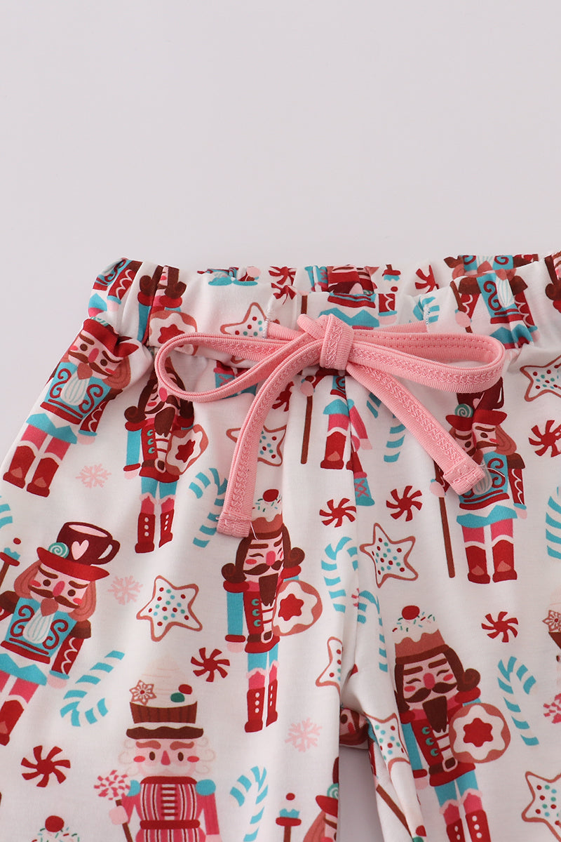 Children's pajama set with nutcracker design on a white background